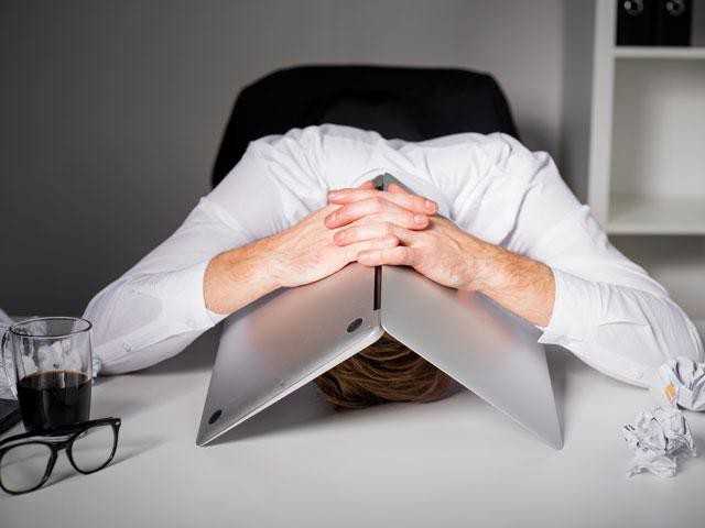 Person with laptop folded over their head while taking a work nap